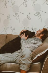 Home-4-Man-with-Dog-On-Couch Home-4-Man-with-Dog-On-Couch